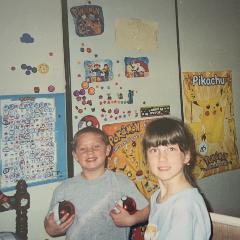 Picture of a young boy and girl in a room full of Pokémon decorations